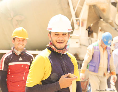 three workers enjoying tea break in a construction site